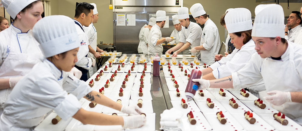 DMACC culinary students preparing a meal at the Iowa Culinary Institute