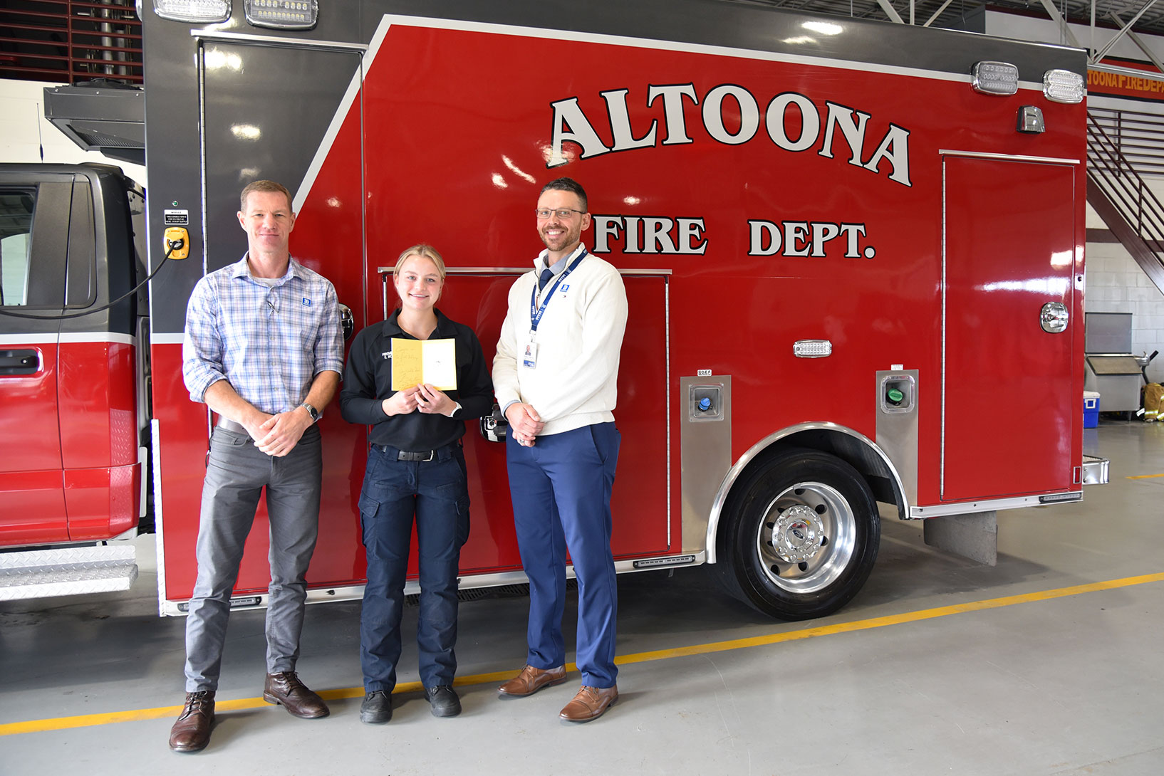 Kolb (above, center) joins Joel Otte (left), DMACC Paramedic Program Chair and Lead Instructor, and Dustyn Dickhaut (right), Coordinator of EMS and Fire Science Education at DMACC, for a celebratory photo on Nov. 1, at the Altoona Fire Department​.