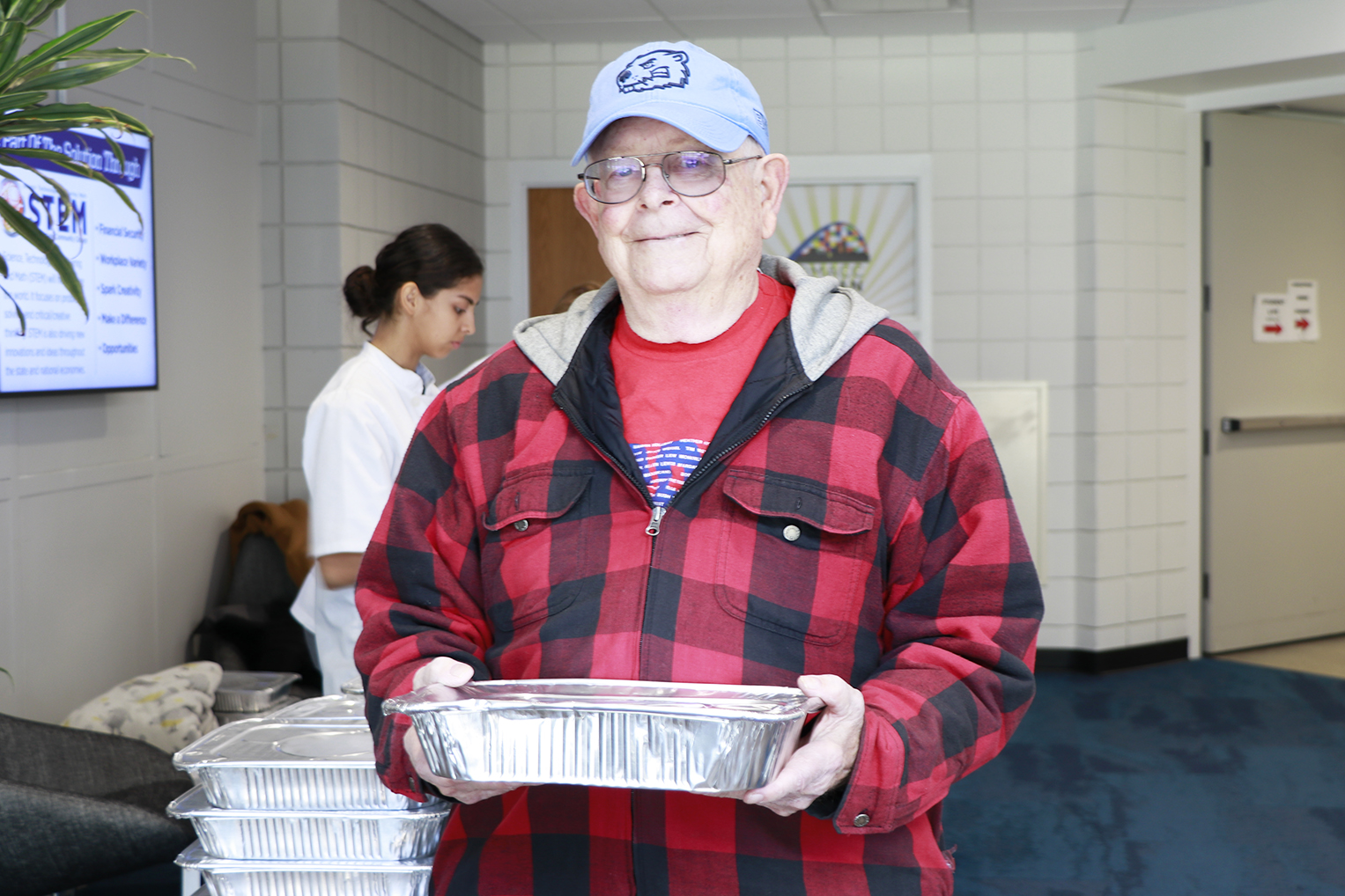Lonnie Evans of Urbandale poses for a quick photo on Wed., Nov. 22, 2023, at the DMACC Urban Campus after picking up his order of a dozen dinner rolls through the DMACC Baking and Pastry Arts program's Fourth Annual Thanksgiving Dinner Roll Fundraiser.