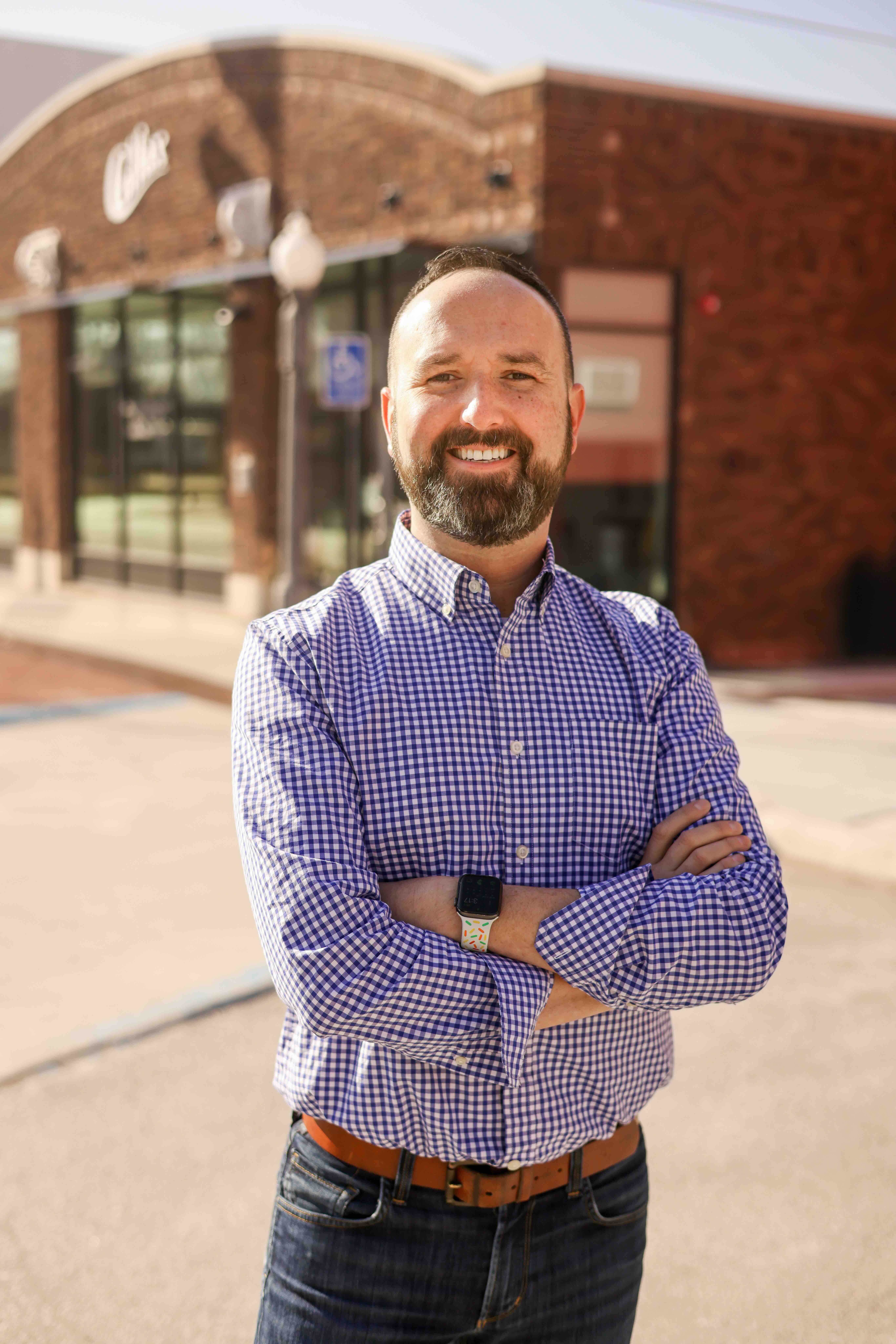 Man stands in downtown Colfax Iowa for headshot photo