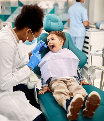 Dental Hygienist checking a child's teeth.
