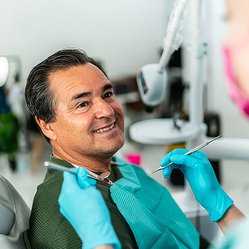 A man smiling as he gets ready for a dental exam