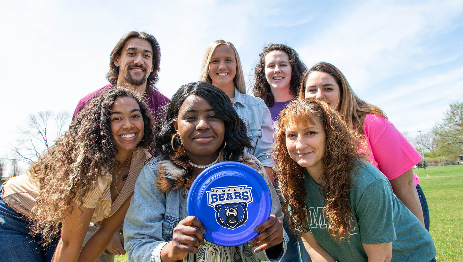 DMACC students on a summer day with a frisbee